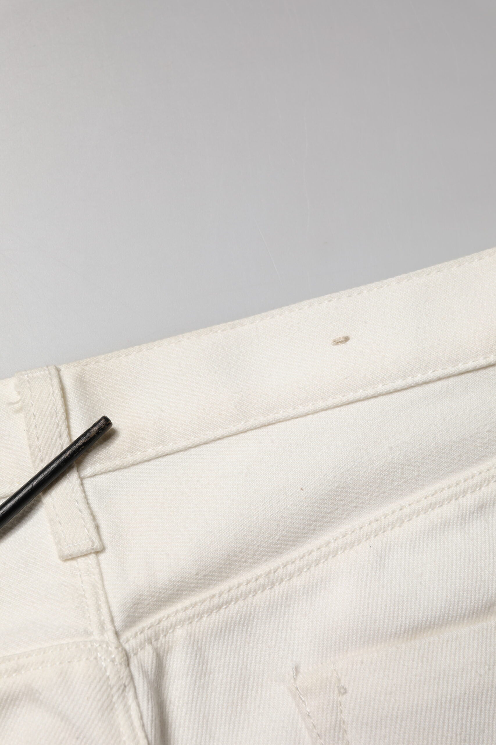 White pants with black button