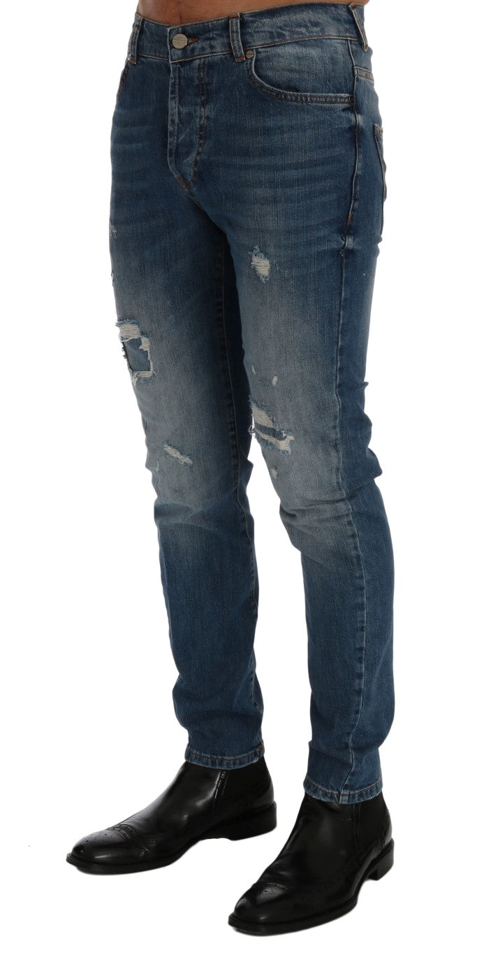 Pair of blue denim jeans with distressed areas on legs
