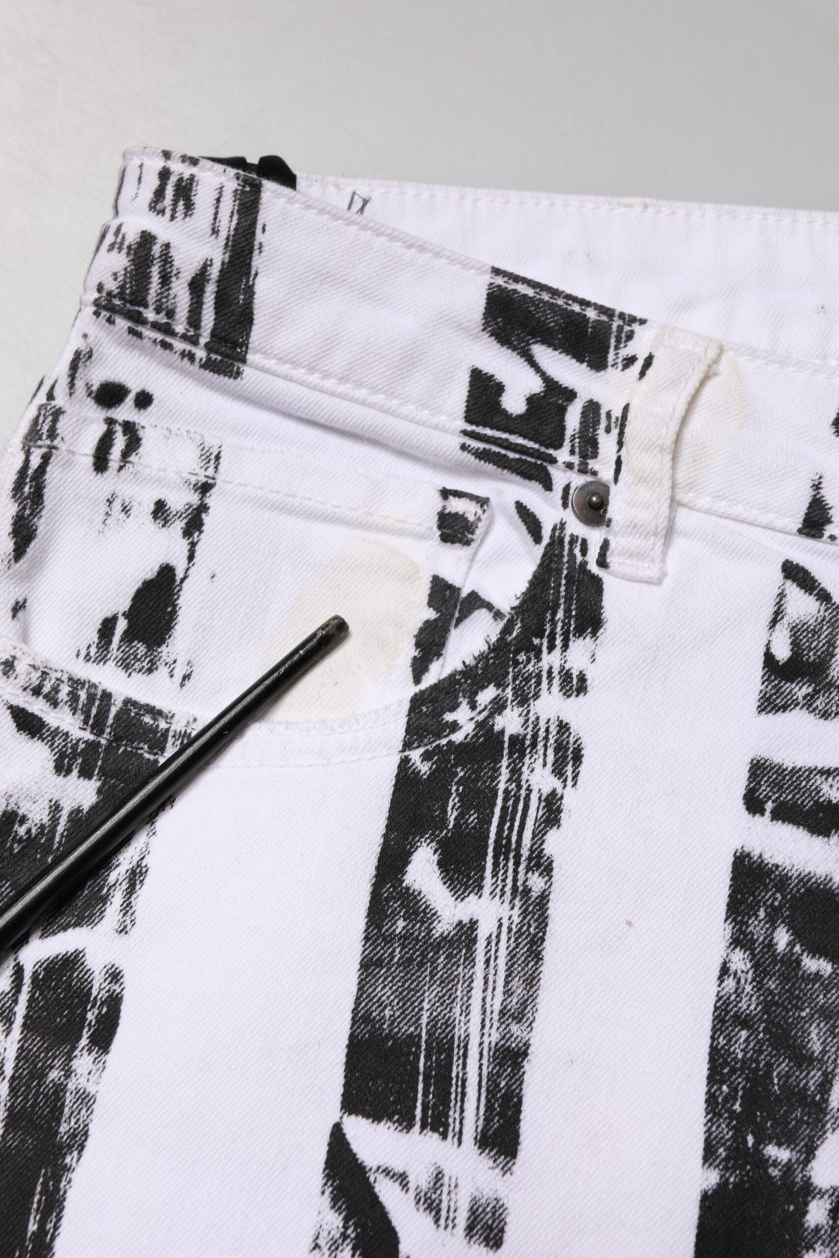 Pair of white pants with black stripes