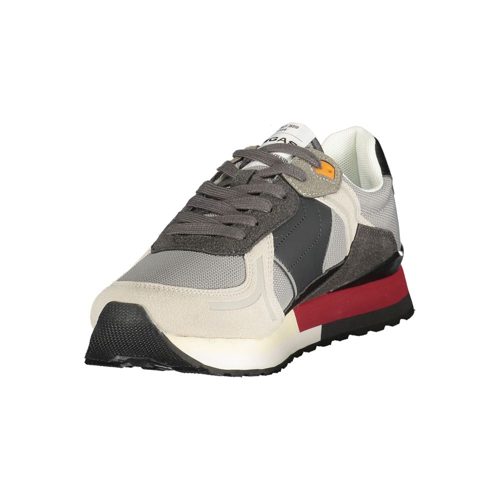 A gray sneaker with red accents