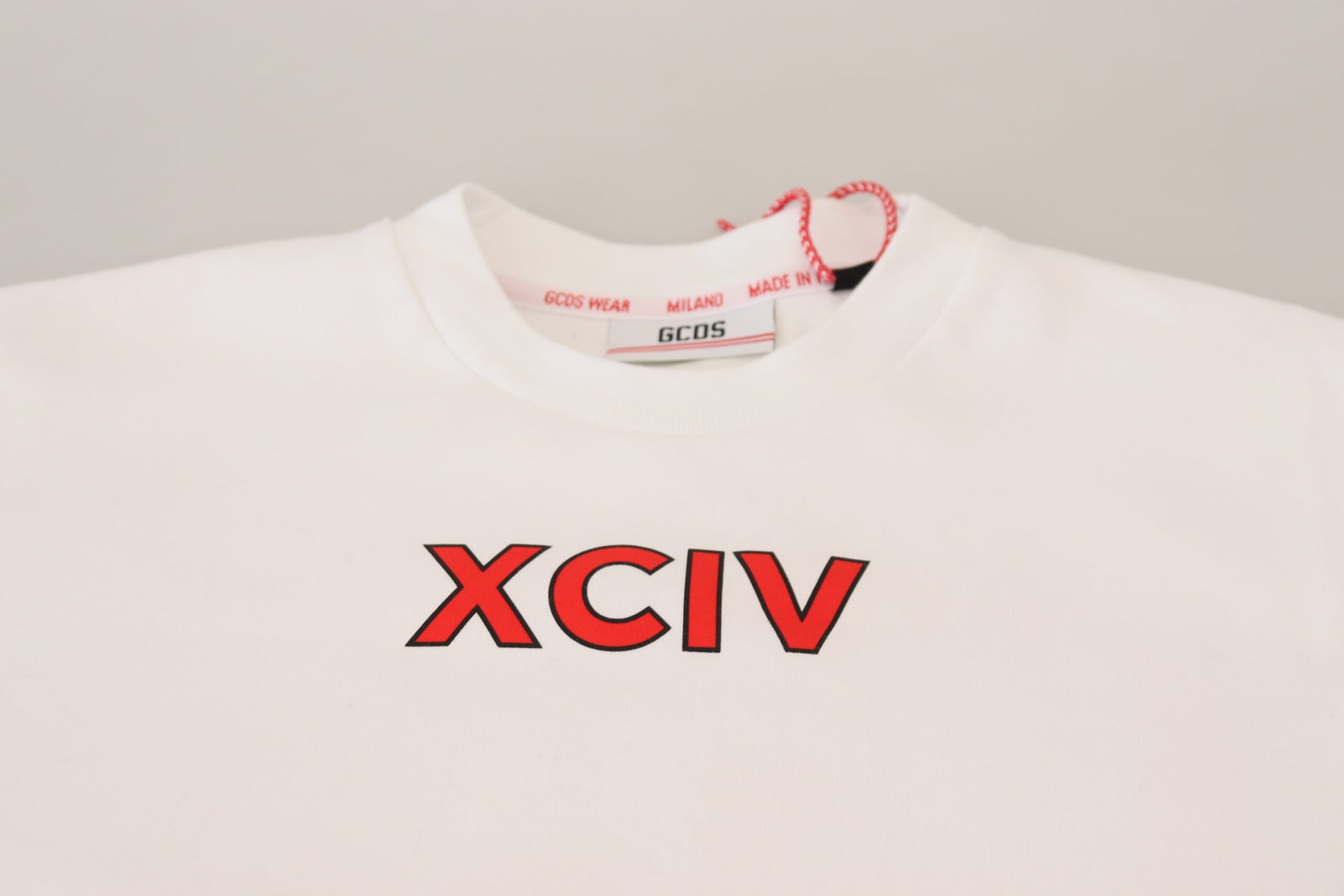 White shirt on hanger with red lettering