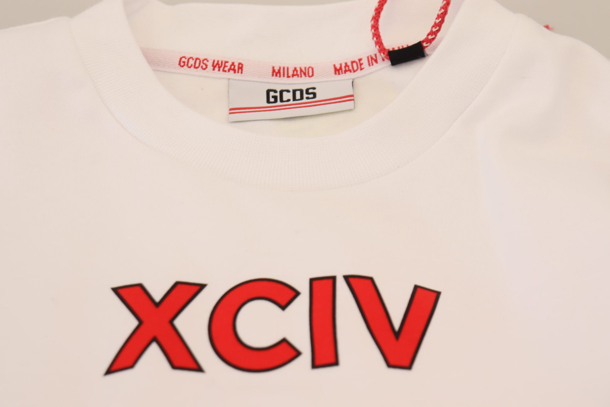 White t-shirt with red lettering and logo