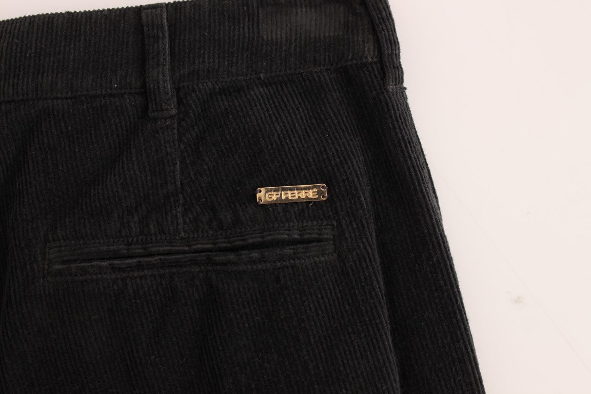 Pair of black jeans with a gold logo on the right leg