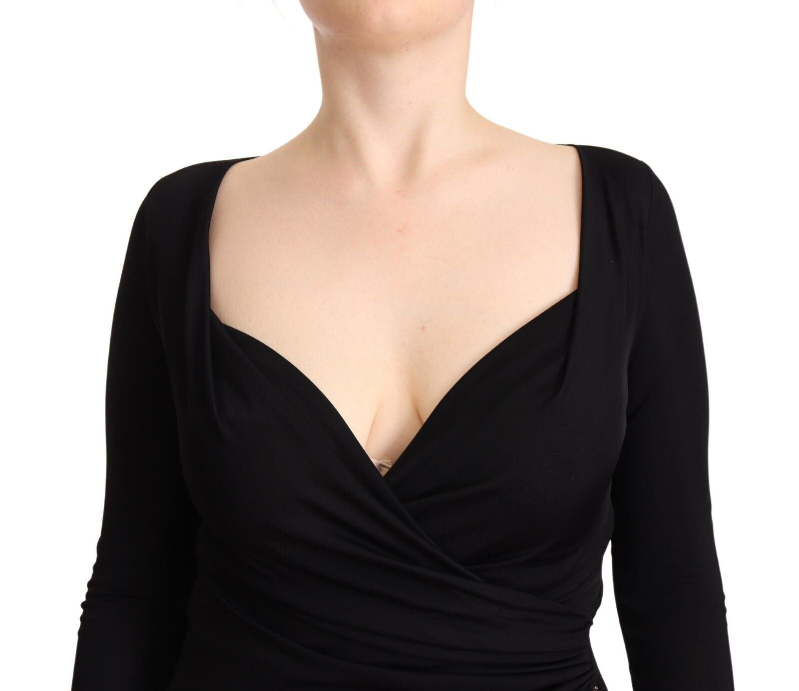 A black long sleeve dress with a sweetheart neckline and midi length