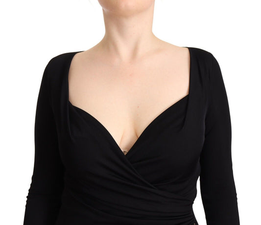 A black long sleeve dress with a sweetheart neckline and midi length