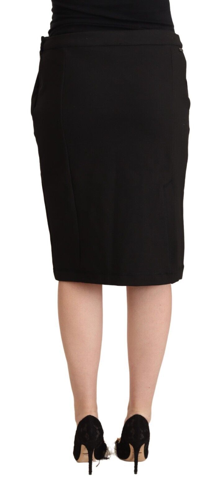 Black skirt worn by a woman standing against a white background