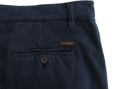Pair of dark blue jeans with a small brown label on the right side