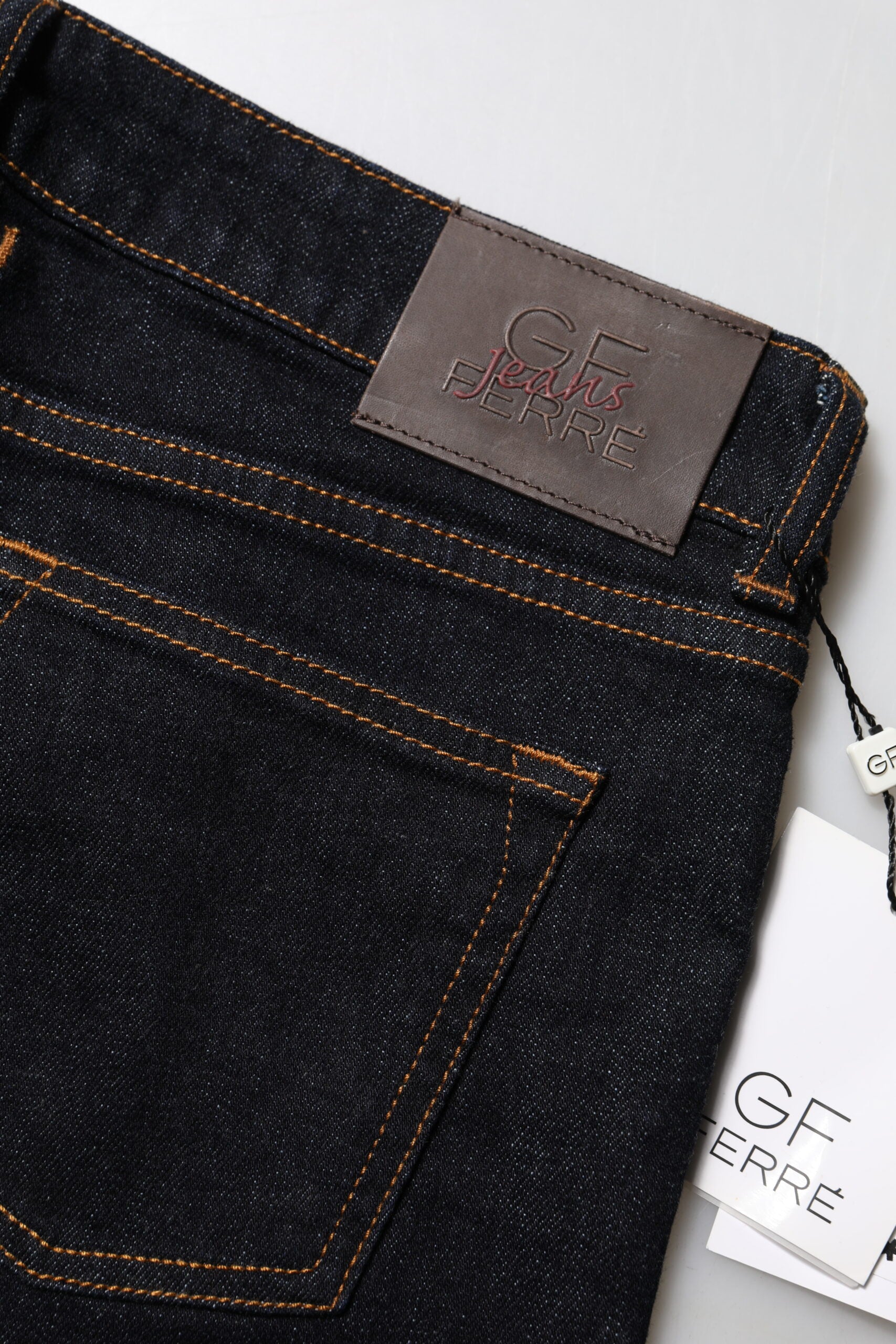 Pair of blue jeans with brown trim on waistband