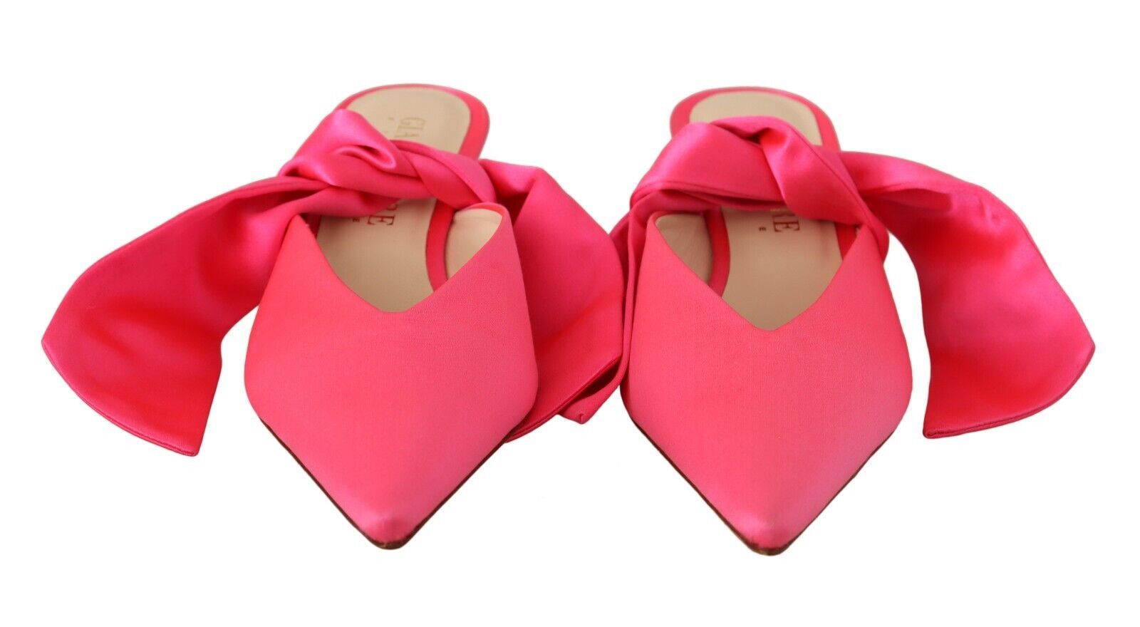 Pair of red high heel shoes with bows on top