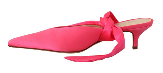 Pair of red high heel shoes with bow on top