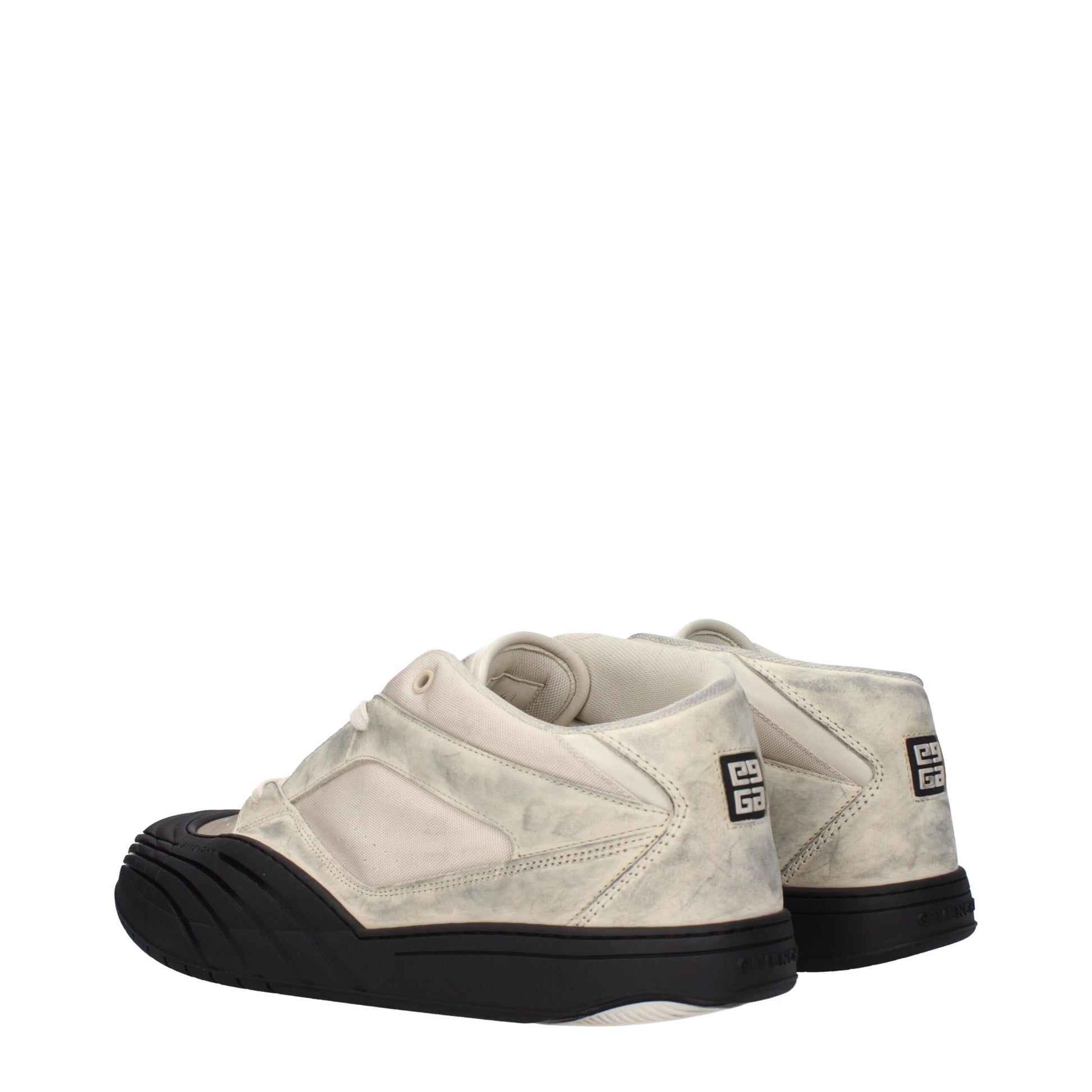 Pair of beige chunky sneakers with black soles, featuring a logo on the side and a textured fabric upper