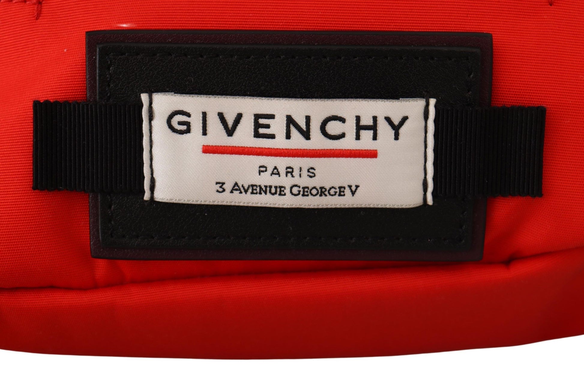 Red label on clothing with brand name in white letters