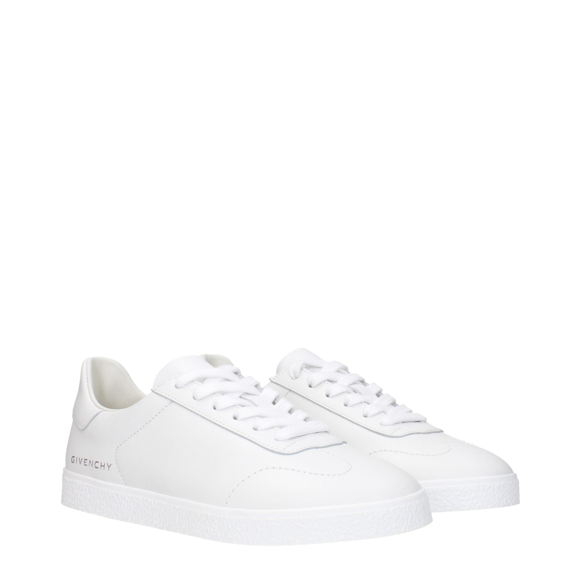 Pair of white leather low top sneakers with laces, featuring brand logo on side and sole