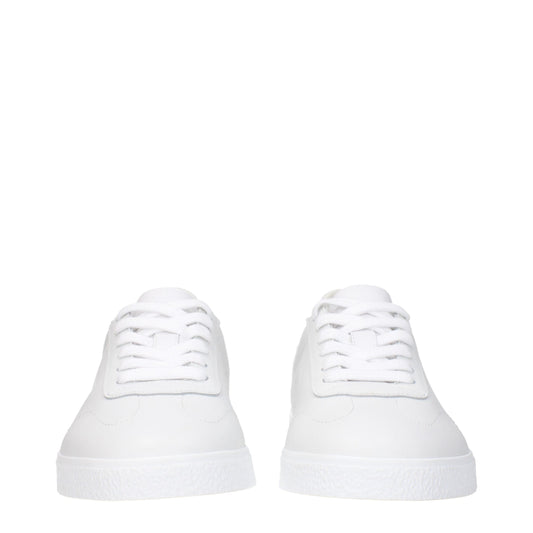 Pair of white leather low top sneakers with laces
