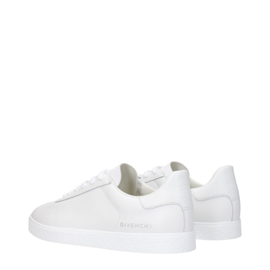 Pair of white leather low top sneakers with black laces, featuring brand name on side and back
