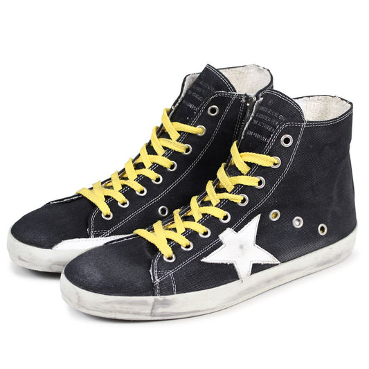 "Golden Goose black canvas sneakers with distressed details and laces."
