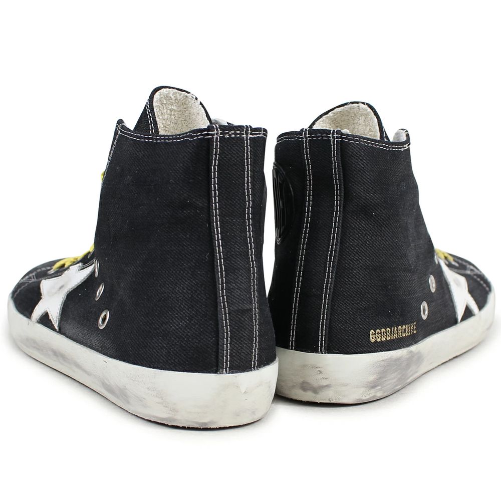 "Golden Goose black canvas sneakers with distressed details and laces."