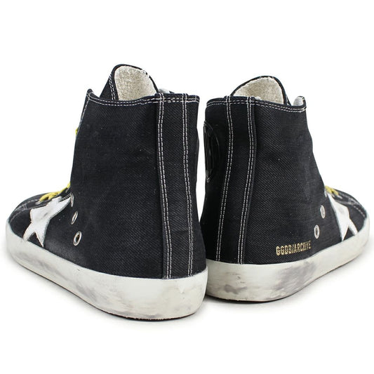 "Golden Goose black canvas sneakers with distressed details and laces."