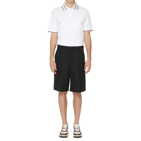 Man wearing white polo shirt and black shorts