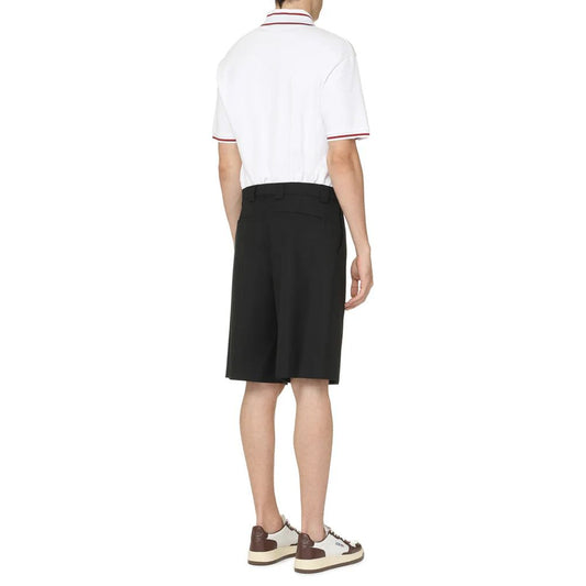 Man wearing white polo shirt and black shorts