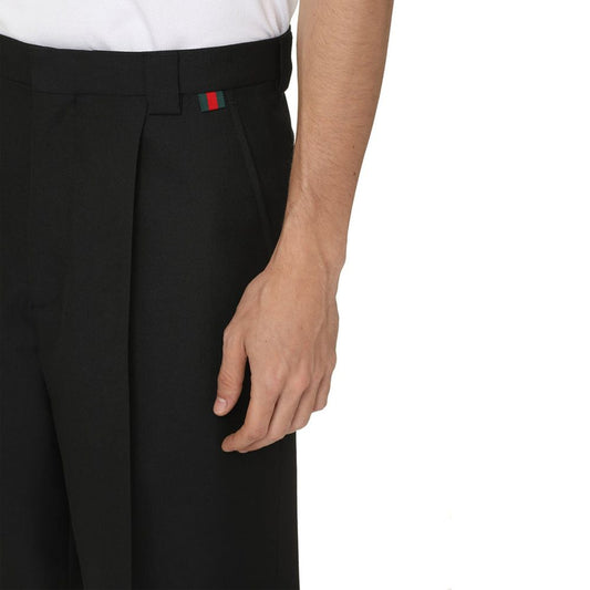 Black trousers with a red logo on the side