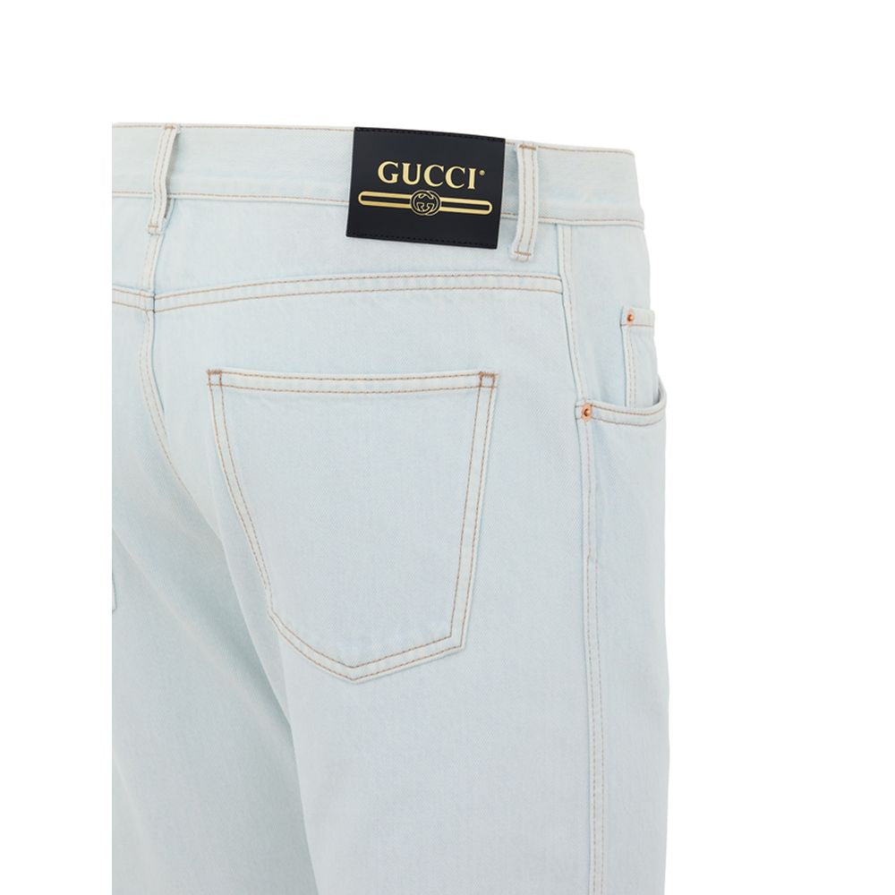 Light blue denim jeans with a Gucci label on the waistband