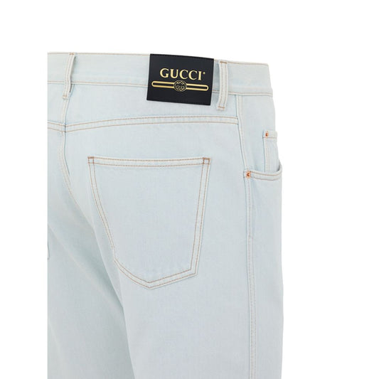 Light blue denim jeans with a Gucci label on the waistband
