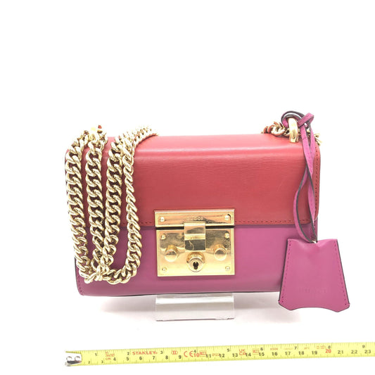 Purple clutch with gold chain necklace