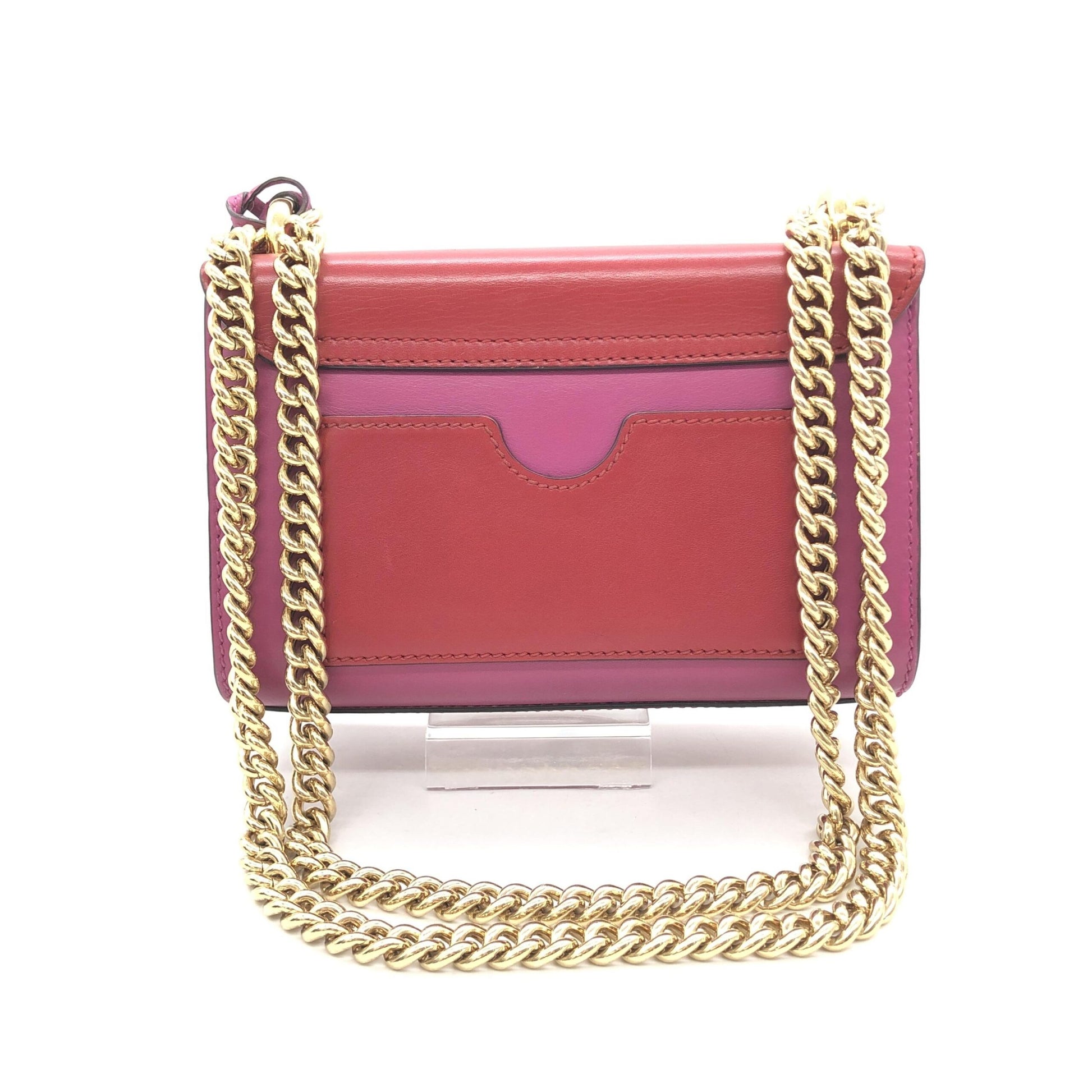 Red purse with gold chain strap