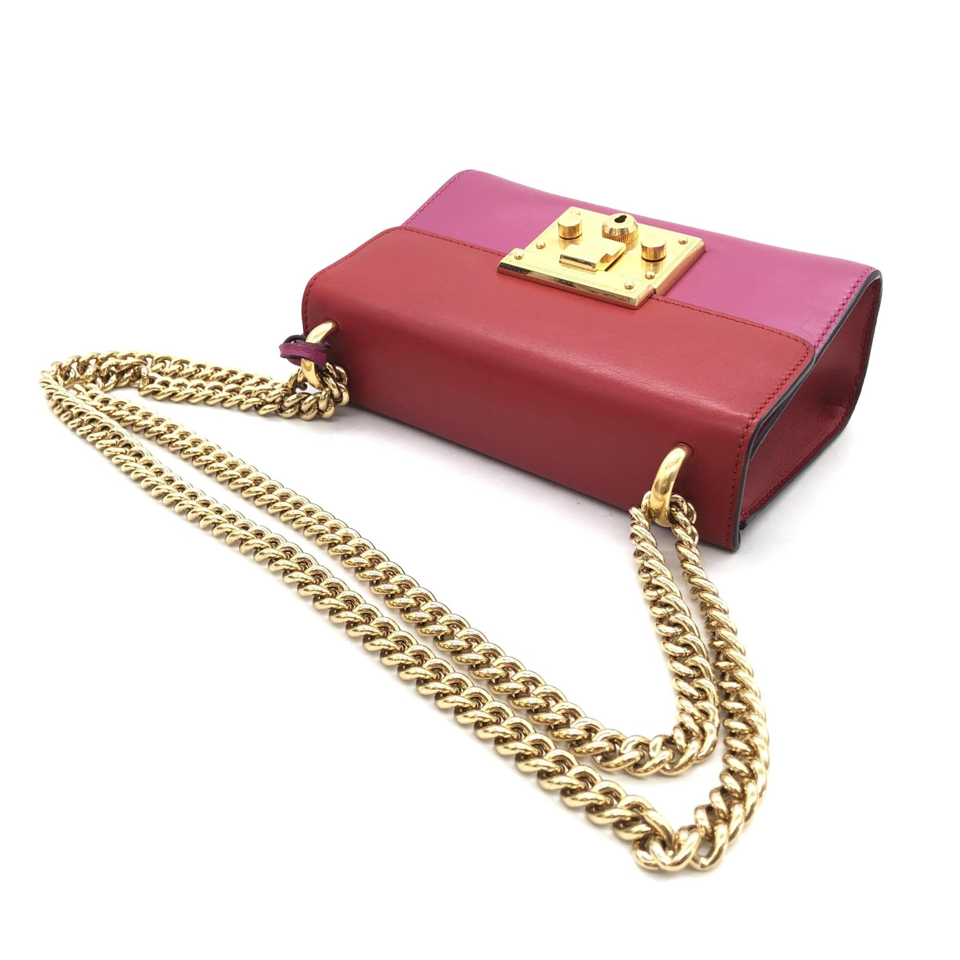 Red purse with gold chain necklace