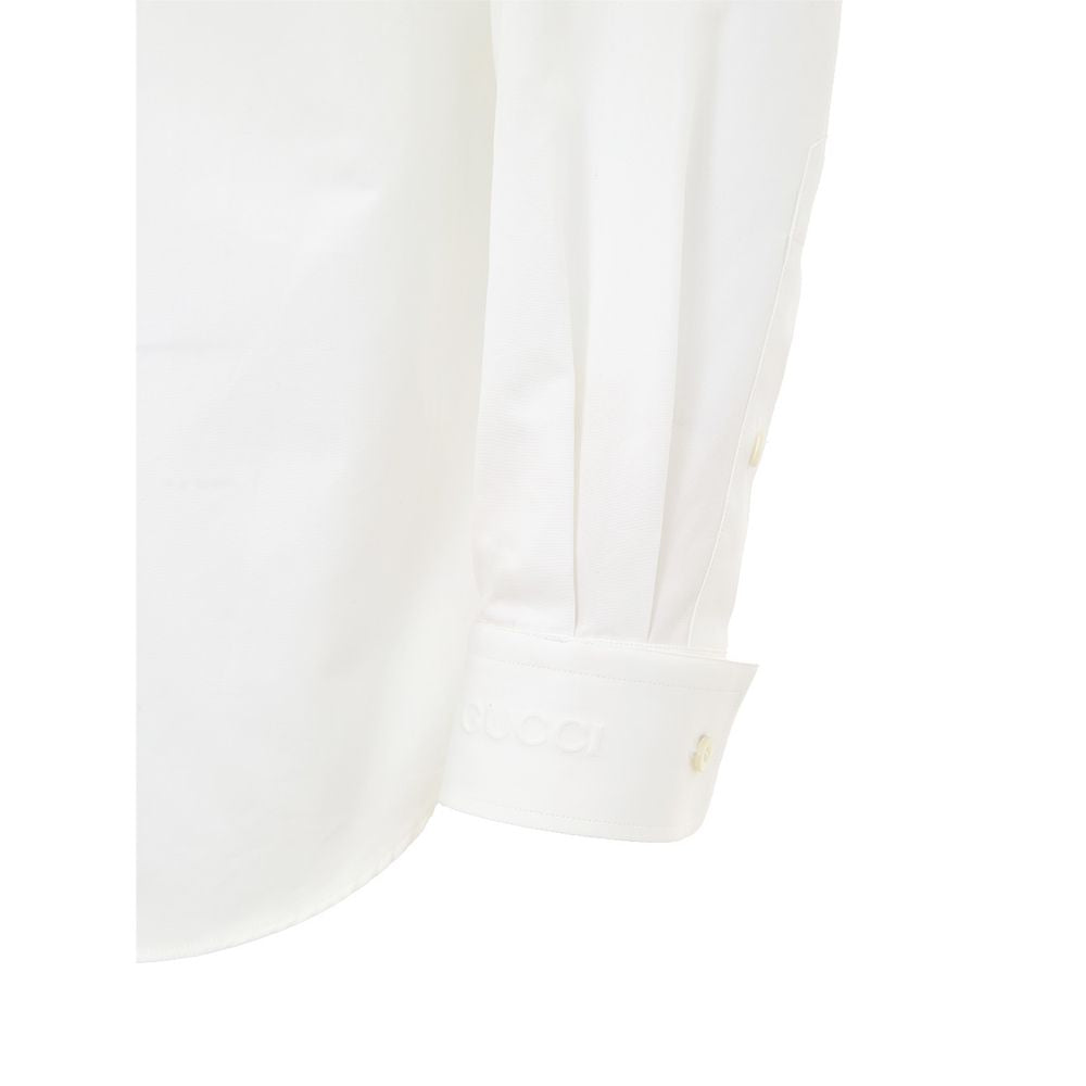 A white cotton dress shirt with a button-up collar, long sleeves, and a placket on the left chest