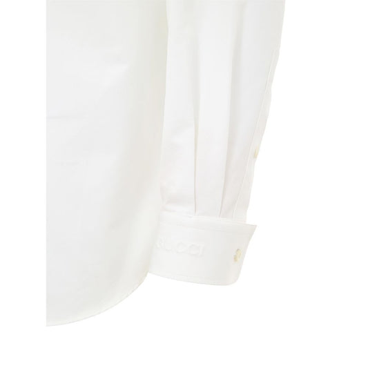 A white cotton dress shirt with a button-up collar, long sleeves, and a placket on the left chest