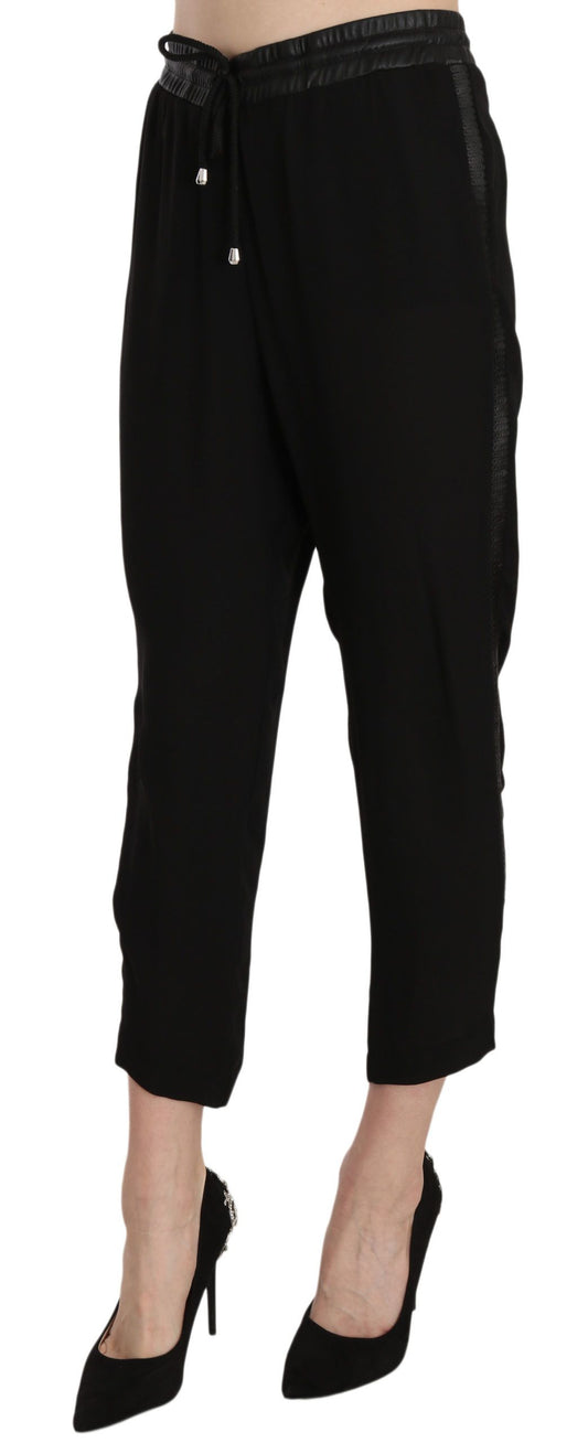 Pair of black pants with rolled up legs