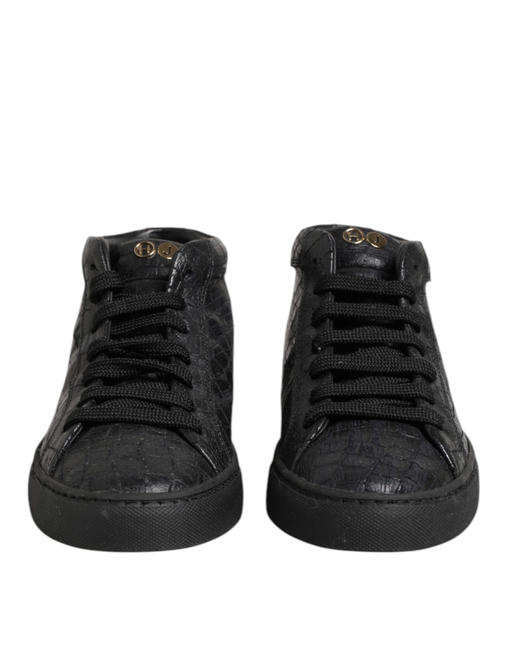 Pair of black sneakers with white laces