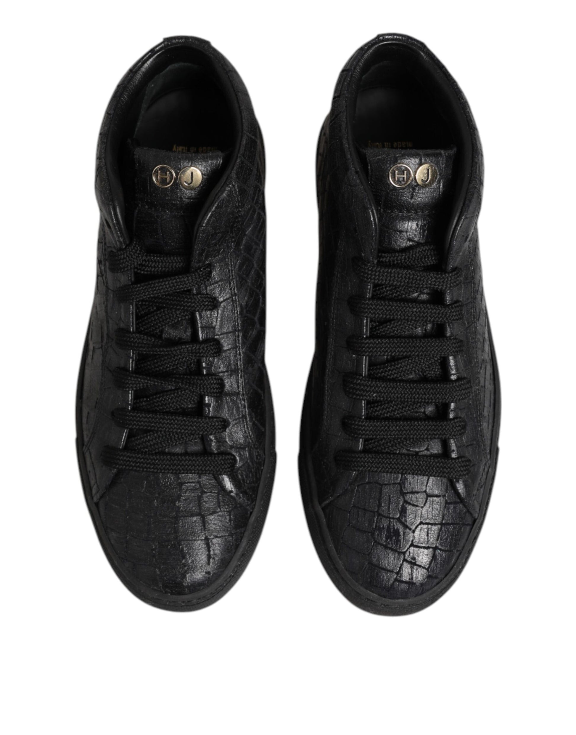 Pair of black sneakers with gold accents