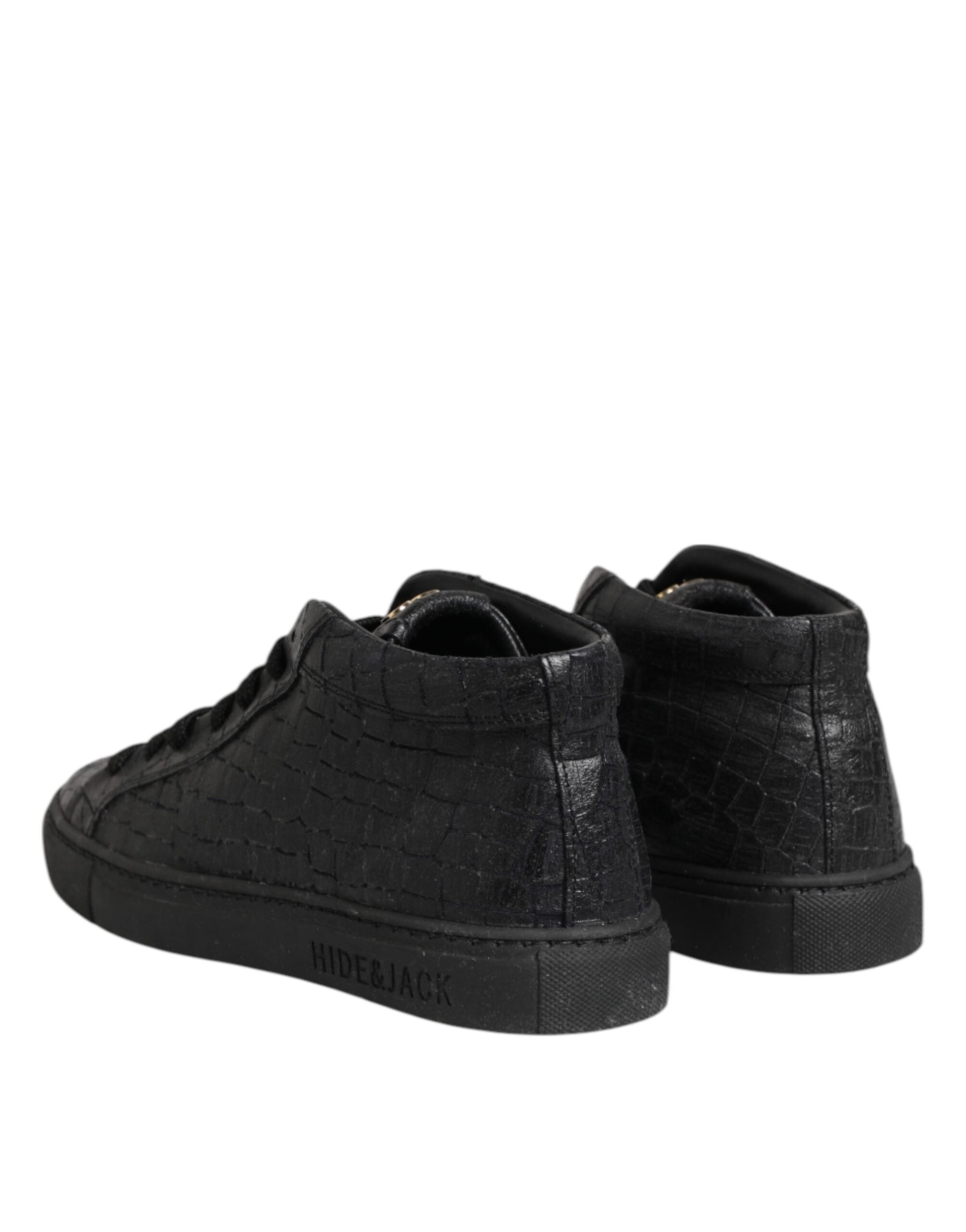 Pair of black sneakers with white soles