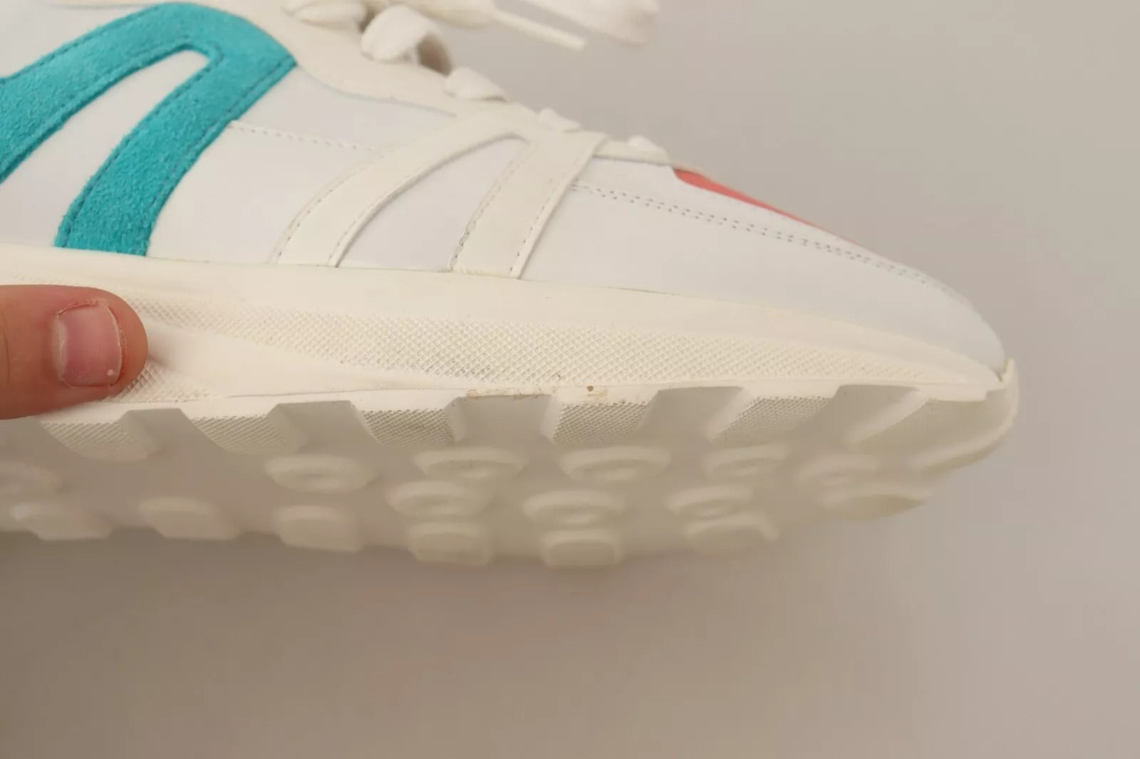White sneaker with blue stripes on side
