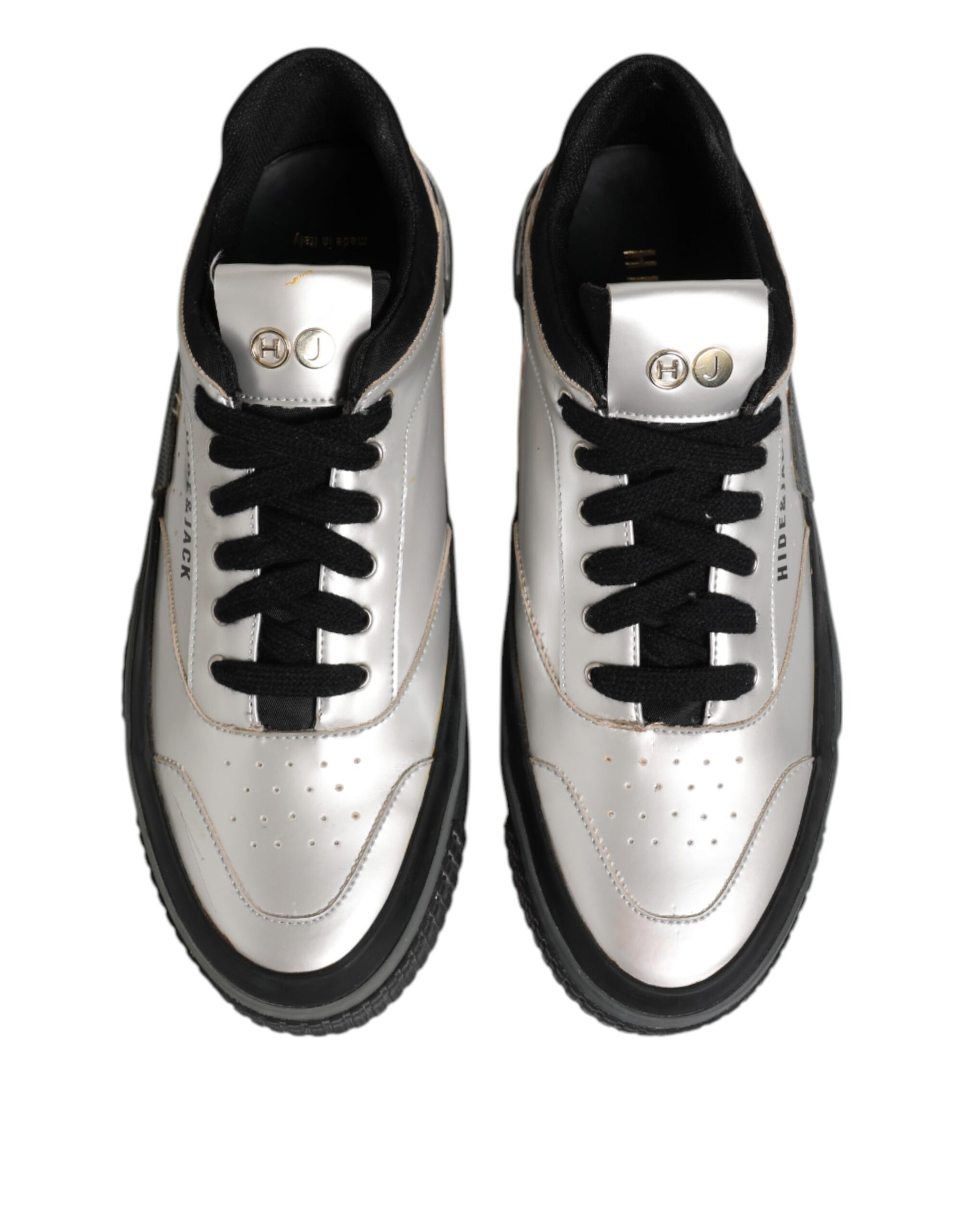 Pair of black and white sneakers with gold accents