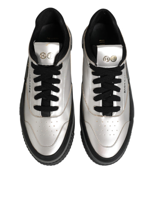 Pair of black and white sneakers with gold accents