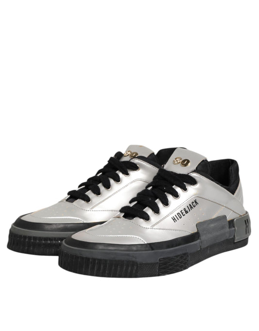 Silver sneakers with black laces and gold accents