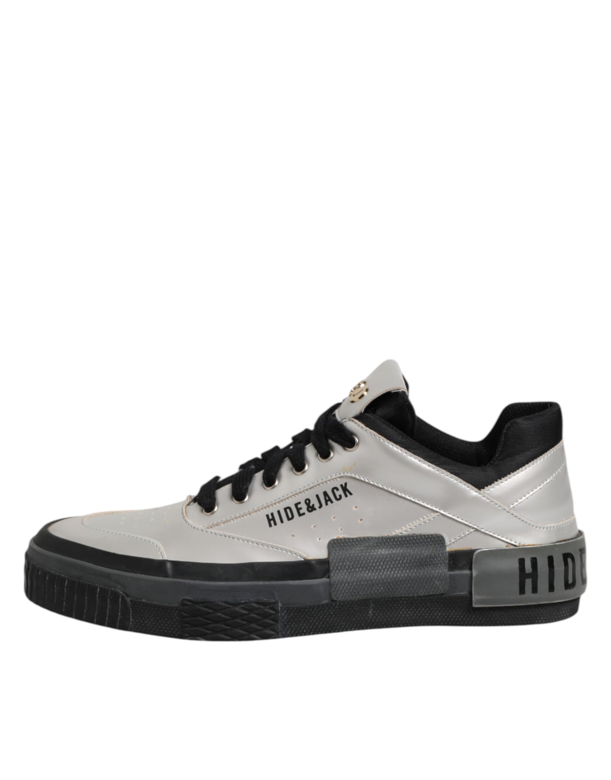 White sneaker with black laces and gold accents