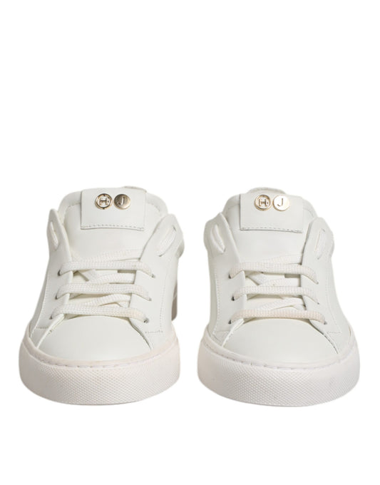 Pair of white baby shoes with gold buckles
