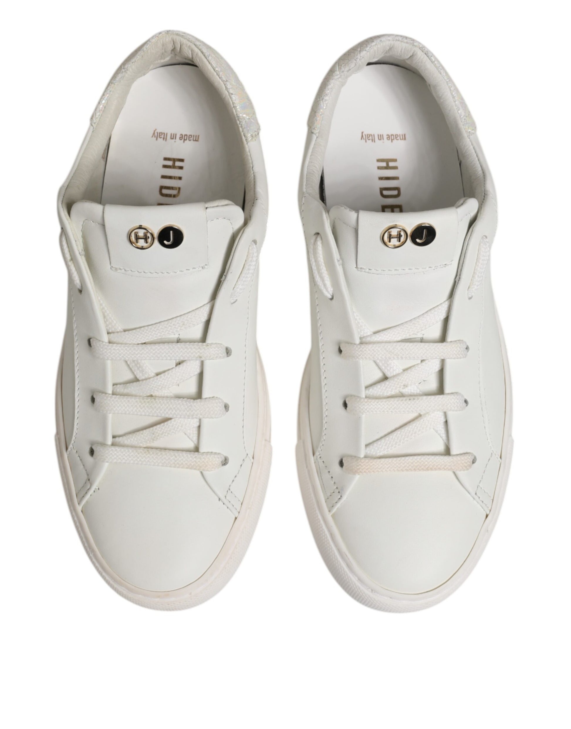 Pair of white sneakers with gold accents