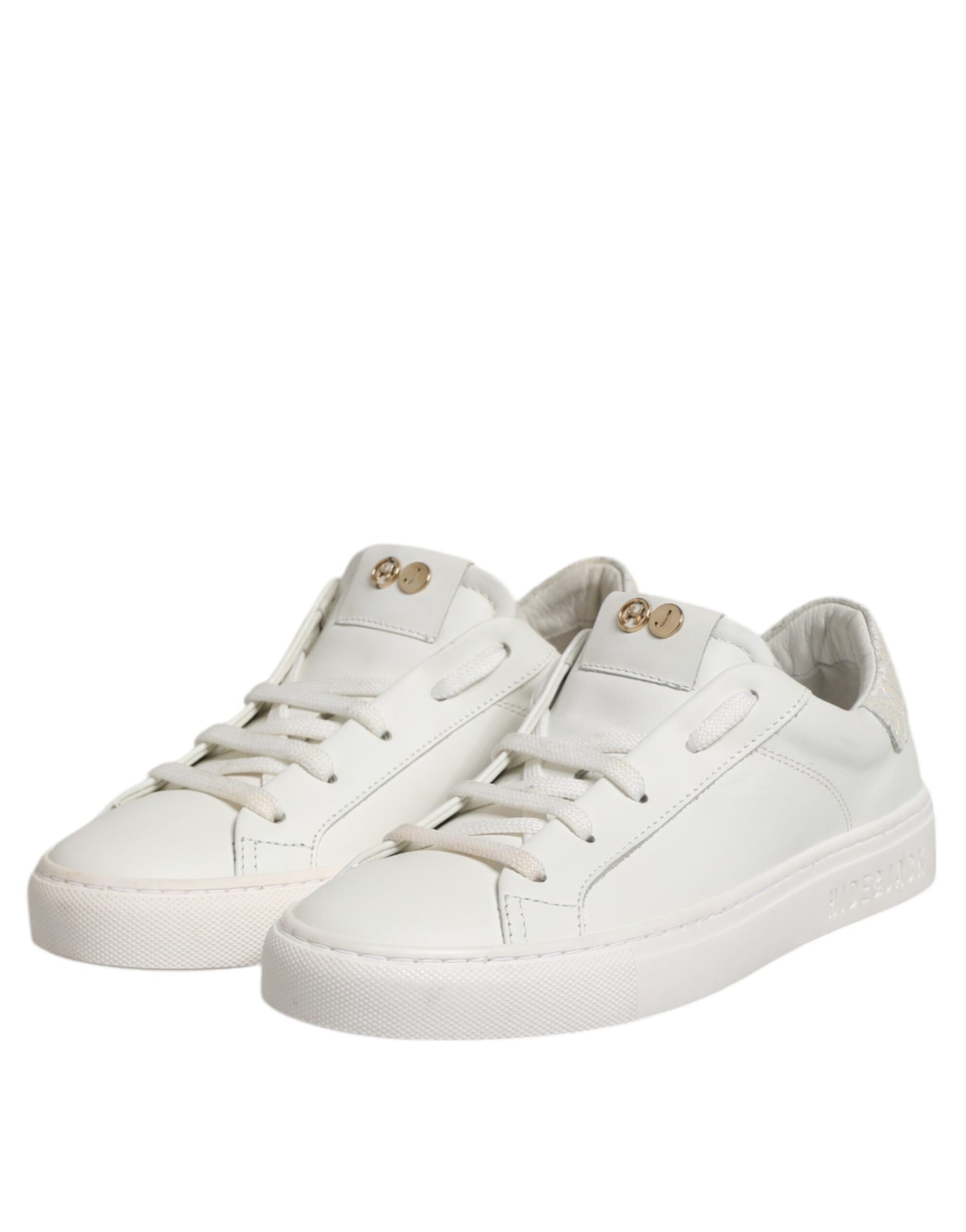 Pair of white sneakers with gold accents