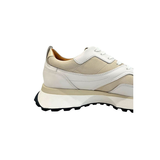 A white leather men's sneaker with a tan sole, featuring laces and a low top design