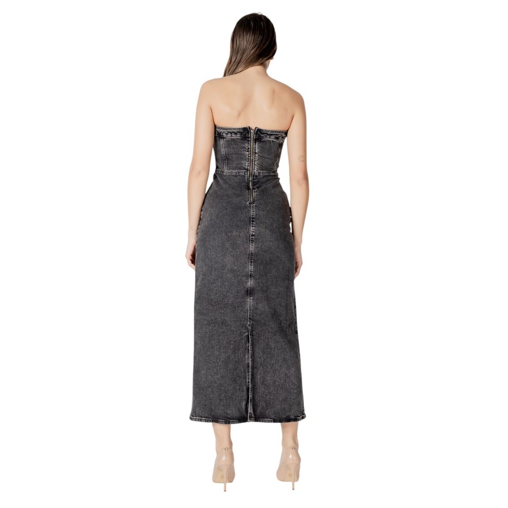 A black midi dress with a denim-like texture, featuring a V-neckline and a backless design