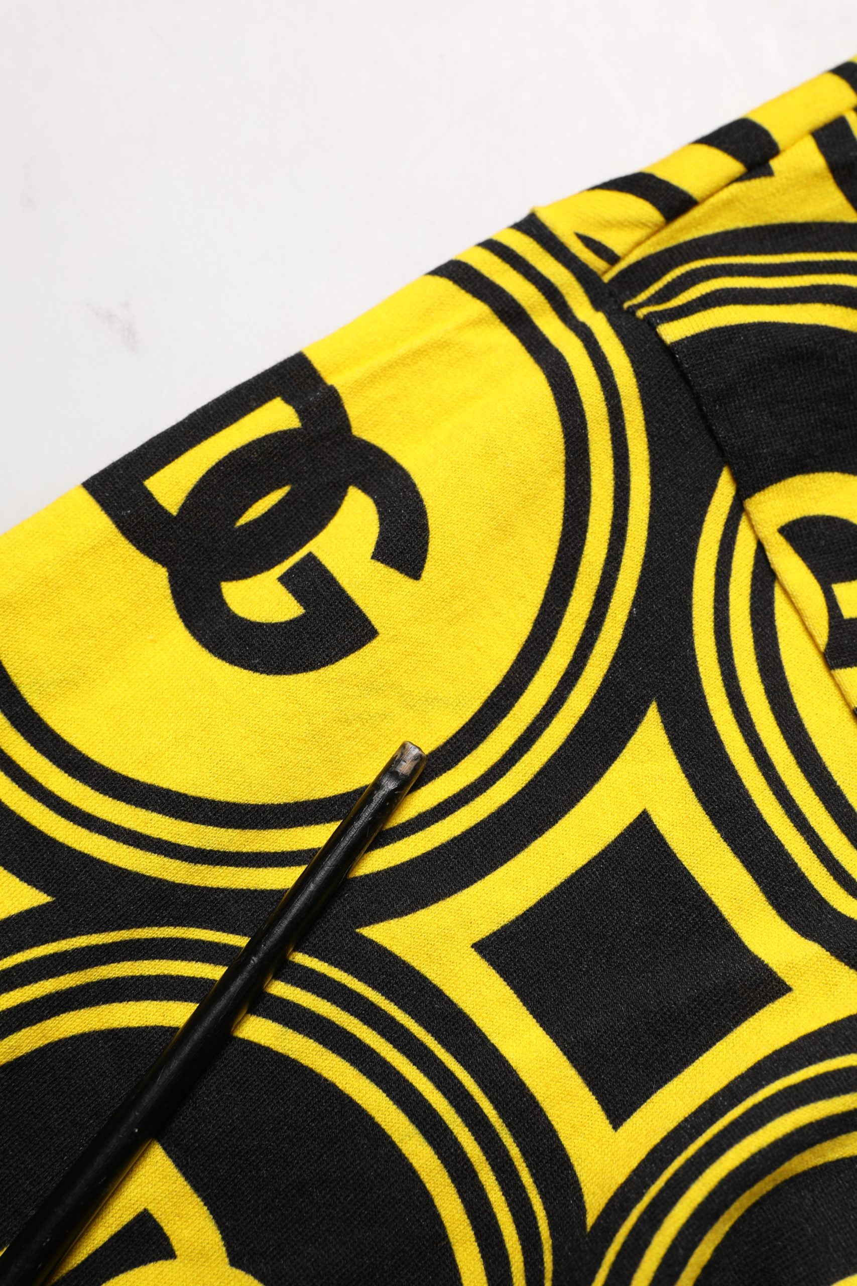 Yellow towel with black logo