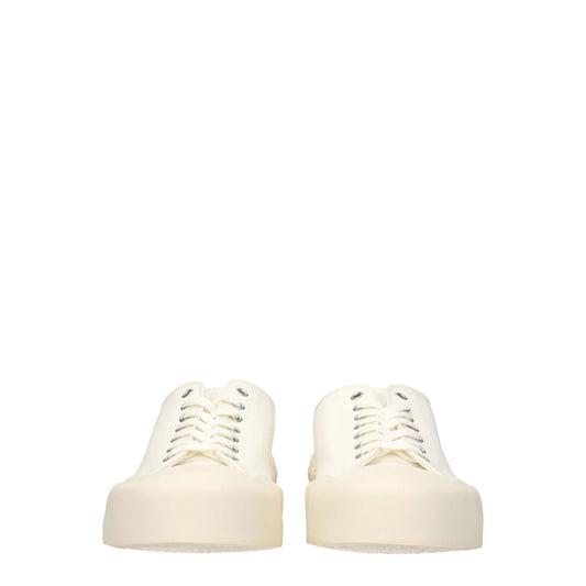 Pair of beige fabric low top sneakers with lace-up front and chunky heel