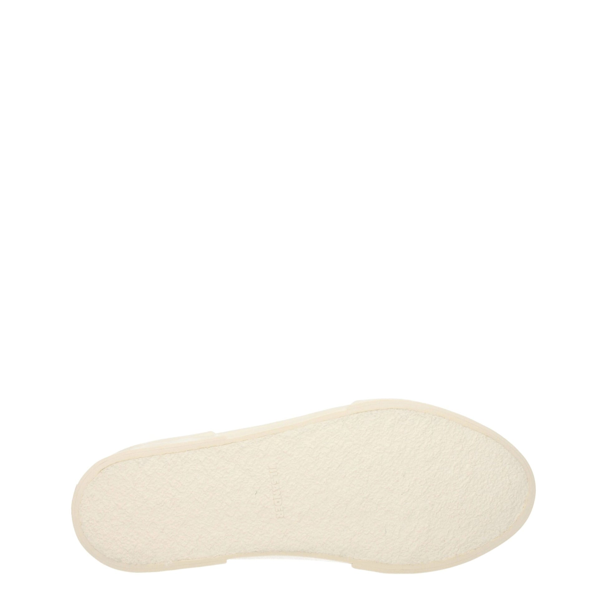 A beige fabric low top sneaker with a round toe and flat sole