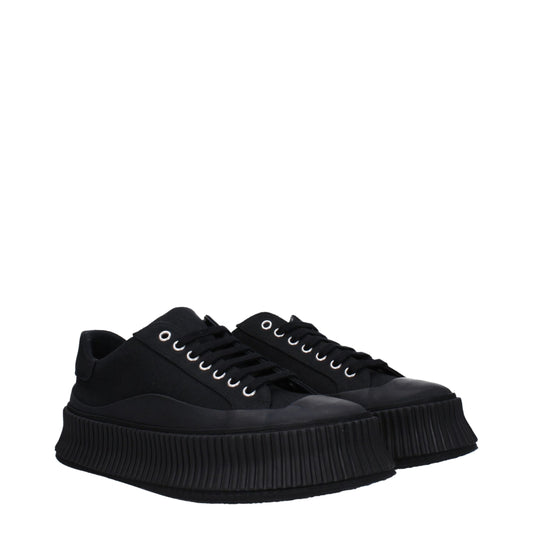 A pair of black platform sneakers with a chunky sole, featuring a lace-up front and a low top design